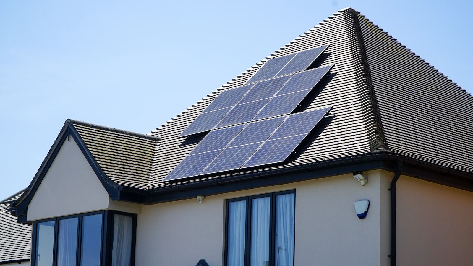 Solar panels installed on a UK house roof in bright sunshine